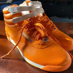 Orange and white Reebok princess high tops.